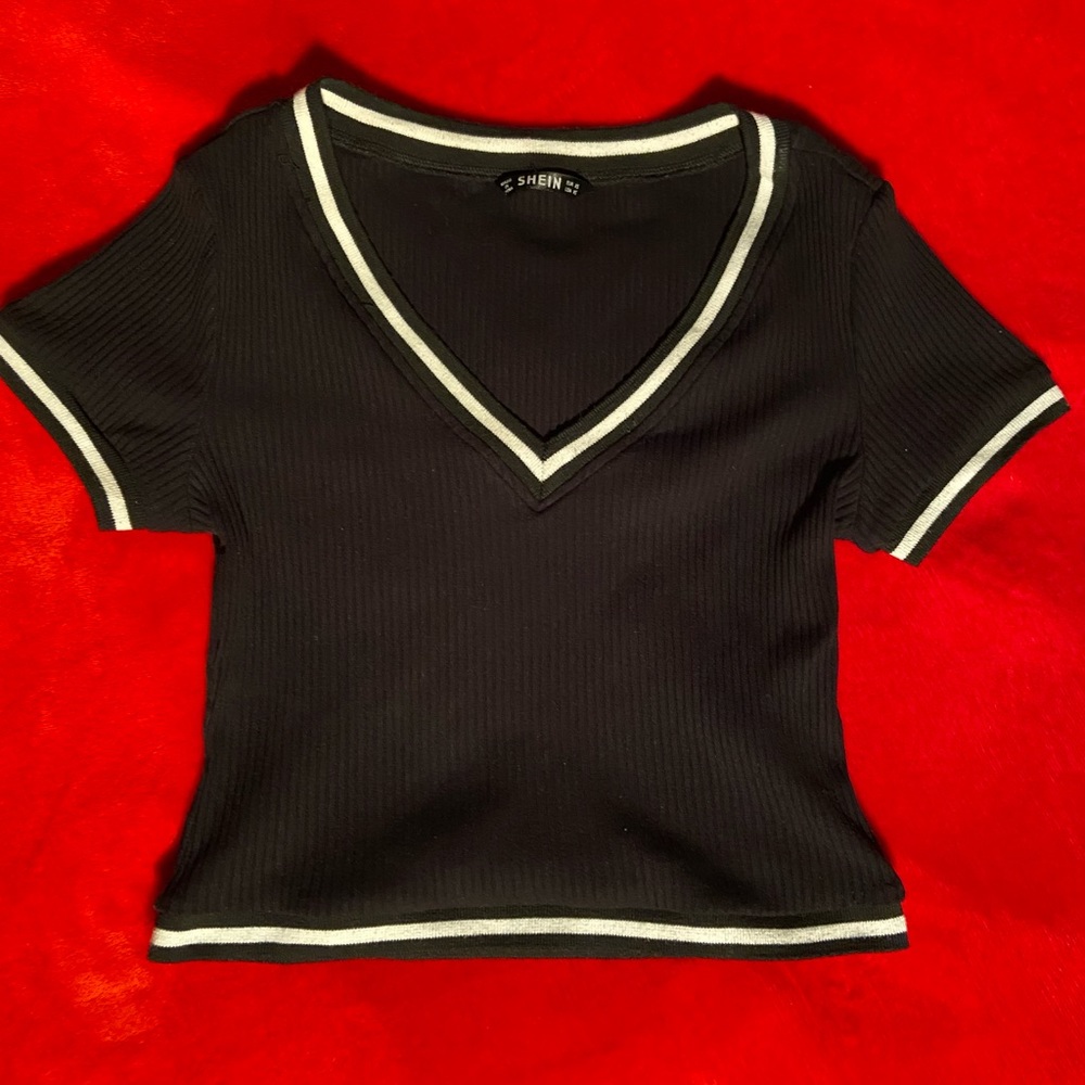 black crop top with white detail.